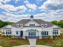 Community clubhouse with a white exterior and landscaping at 3209 Whispering Creek Dr # 154, Indian Trail, NC 28079