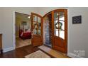 Elegant foyer with hardwood floors and view into a beautifully decorated bedroom at 341 Canvasback Rd, Mooresville, NC 28117