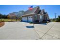 Spacious three-car garage with an American flag against a blue sky backdrop at 341 Canvasback Rd, Mooresville, NC 28117