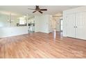 Open living room with hardwood floors and views of kitchen at 4211 Suttle Pl, Matthews, NC 28104