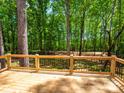 Enjoy the wooded backyard view from this spacious wood deck with metal railings at 4607 Ferguson Cir, Waxhaw, NC 28173