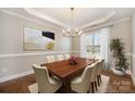 Formal dining room featuring a modern chandelier, large window, and neutral wall color at 5115 Waterloo Dr, Fort Mill, SC 29708