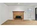 Cozy living room with a brick fireplace, mantle and a large window with shutters at 5818 Harris Grove Ln, Charlotte, NC 28212