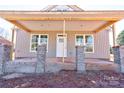 New construction home featuring a covered porch with brick columns and a white front door at 604 E Ridge St, Kings Mountain, NC 28086