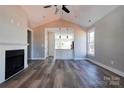 Bright living room featuring hardwood floors, a fireplace, and an open view into the modern kitchen at 604 E Ridge St, Kings Mountain, NC 28086