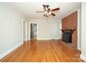 Hardwood floor living room with brick fireplace and view of kitchen at 617 York S Ave, Rock Hill, SC 29730