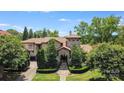 Stone and stucco house with tile roof, landscaping, and driveway at 7213 Fairway Vista Dr, Charlotte, NC 28226