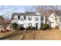 Attractive white two-story home with green shutters and manicured landscaping at 9635 Veronica Dr, Charlotte, NC 28215