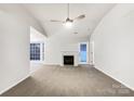 Spacious living room with fireplace and neutral carpeting at 10306 Creswell Ct, Charlotte, NC 28215