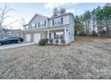 Two-story townhome with gray siding, brick accents, and a two-car garage at 1033 Cedar Village Trl, Salisbury, NC 28147