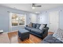 Bright living room featuring hardwood floors, a large window, and comfortable seating at 1107 Stonehenge Ln, Charlotte, NC 28216