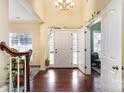 Bright entryway with hardwood floors, a white door, and a staircase at 13618 Pacific Echo Dr, Charlotte, NC 28277