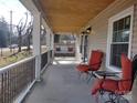 Relaxing front porch with seating and a porch swing at 1443 Modena St, Gastonia, NC 28054