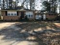 Brick ranch house with a large yard and driveway at 1825 Herrin Ave, Charlotte, NC 28205