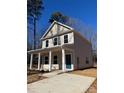 Two-story house with light beige siding, a blue door, and a paved driveway at 203 Benfield Rd, Kings Mountain, NC 28086