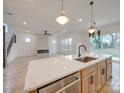 Modern kitchen with light wood cabinets, quartz countertops, and island at 2039 Renner St, Charlotte, NC 28216