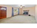 Living room with a brick fireplace and carpet flooring at 214 Costner Dr, Bessemer City, NC 28016