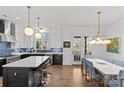 Modern kitchen with white and dark blue cabinets, quartz countertops, and island at 2549 Vail Ave, Charlotte, NC 28207