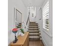 Modern staircase with patterned carpet runner and light-filled landing at 2549 Vail Ave, Charlotte, NC 28207