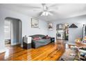 Cozy living room with wood floors, a ceiling fan, and an archway leading to the kitchen at 2907 1St Nw Ave, Hickory, NC 28601