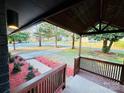 Inviting covered front porch with red mulch landscaping, perfect for enjoying the outdoors at 3027 Remington St, Charlotte, NC 28216