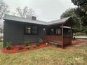 Charming one-story home with a welcoming porch and newly installed landscaping at 3027 Remington St, Charlotte, NC 28216