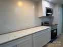 Modern kitchen featuring white cabinets and quartz countertops at 3027 Remington St, Charlotte, NC 28216