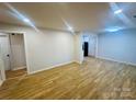 Spacious living room featuring recessed lighting and newly installed floors, creating a modern ambiance at 3027 Remington St, Charlotte, NC 28216