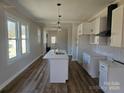 Modern kitchen featuring white cabinets, marble countertops, and a large island at 330 West Blvd, Charlotte, NC 28203