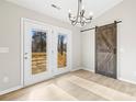 Dining area with barn door and access to deck at 344 Luther Scronce Rd, Vale, NC 28168