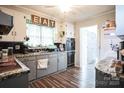 Galley style kitchen with gray cabinets and granite countertops at 400 Charles St, Spencer, NC 28159