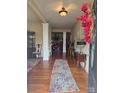 Inviting foyer with hardwood floors, decorative rug, and charming decor at 5421 Roberta Meadows Ct, Concord, NC 28027