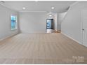 Large living room with beige carpet and entryway view at 744 Bartram Ave, Concord, NC 28025