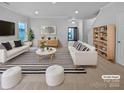 Spacious living room with white sofas and striped rug at 744 Bartram Ave, Concord, NC 28025