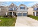 Two-story house with gray siding, stone accents, and a two-car garage at 8023 Alford Rd, Fort Mill, SC 29707