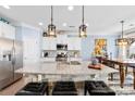 Kitchen island with granite countertop and breakfast bar seating at 8023 Alford Rd, Fort Mill, SC 29707