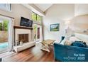 Living room with fireplace, hardwood floors, and access to patio at 8049 Charter Oak Ln, Charlotte, NC 28226