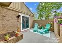 Private patio with teal furniture and landscaping at 8049 Charter Oak Ln, Charlotte, NC 28226