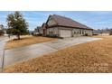 Charming single Gathering home featuring a two-car garage and well-maintained front yard at 8177 Breton Way, Harrisburg, NC 28075