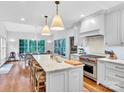 Bright kitchen with white cabinets, marble countertops, and a herringbone backsplash at 9 Pine Tree Rd, Salisbury, NC 28144