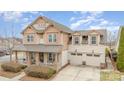 Lovely home showing off its front porch, two-car garage, and detailed exterior trim at 11138 Skytop Dr, Huntersville, NC 28078
