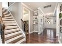Inviting foyer with hardwood floors, staircase, and access to the laundry room at 11138 Skytop Dr, Huntersville, NC 28078
