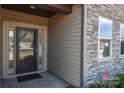 Inviting front entry with a stylish door and stonework detail at 152 Suggs Mill Dr, Mooresville, NC 28115