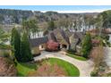 Stunning lakefront home with meticulous landscaping, circular drive, and turret details at 155 Union Chapel Dr, Mooresville, NC 28117
