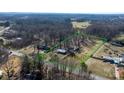 Aerial view of a spacious lot, surrounded by mature trees at 3021 Tryon Courthouse Rd, Bessemer City, NC 28016
