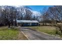 Welcome to your charming home with a convenient driveway and well-maintained lawn at 3021 Tryon Courthouse Rd, Bessemer City, NC 28016