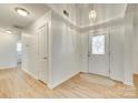 Bright entryway with white walls, wood-look floors, and a decorative front door at 4648 Madeline Dr, Rock Hill, SC 29732