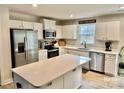 Bright, eat-in kitchen features stainless steel appliances, quartz countertops, and classic white cabinets at 505 Grandiflora Ave, Lancaster, SC 29720