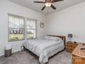 Cozy bedroom with striped bedding, wood nightstand, and ceiling fan at 5220 Admirals Lndg, Lancaster, SC 29720