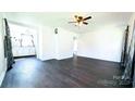 Bright living room featuring dark hardwood floors and a ceiling fan at 556 6Th St, Chester, SC 29706